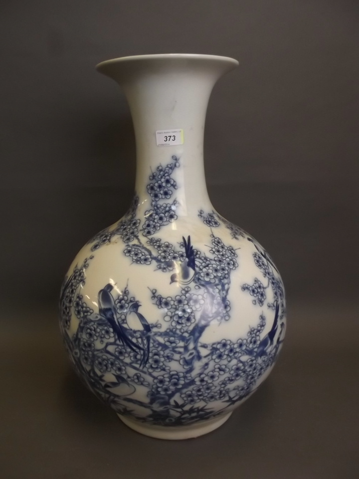 A large early C20th Chinese blue and white bulbous pottery vase painted with birds amongst