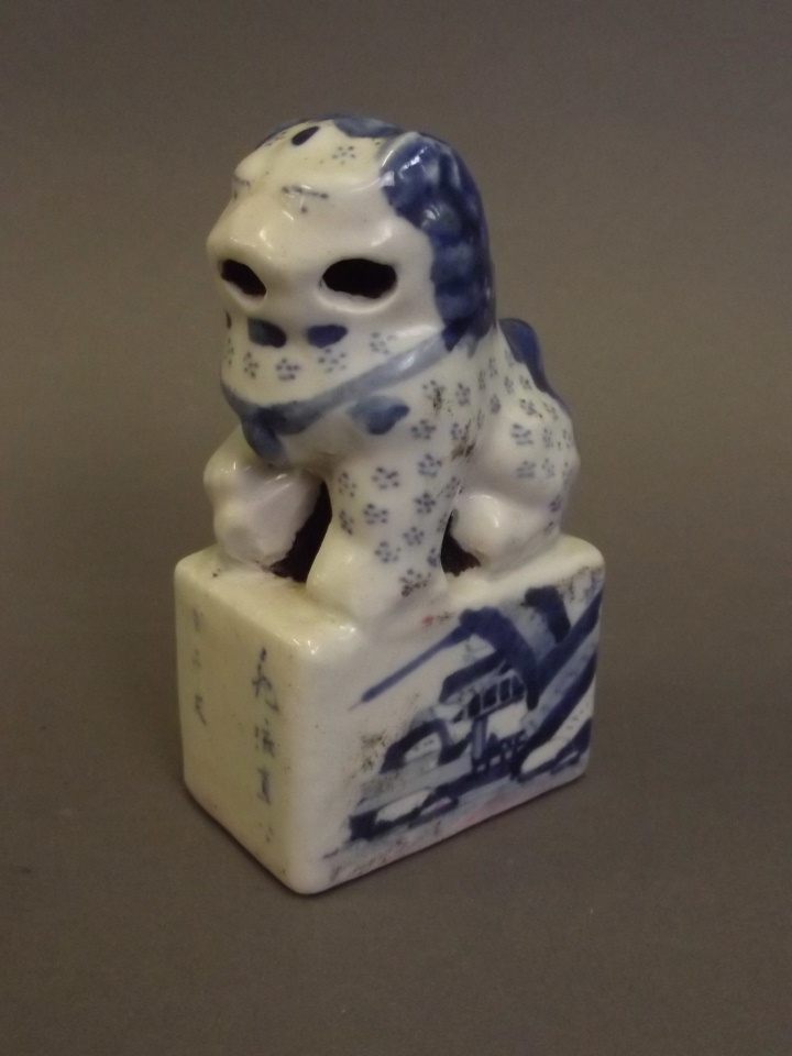 A Chinese blue and white pottery seal in the form of a Fo dog with landscape and character