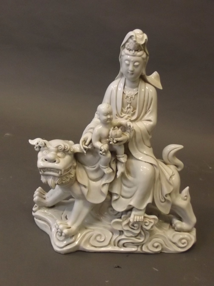 A blanc-de-chine figure of Quan Yin riding a kylin, impressed mark verso, 16¼'' x 14''