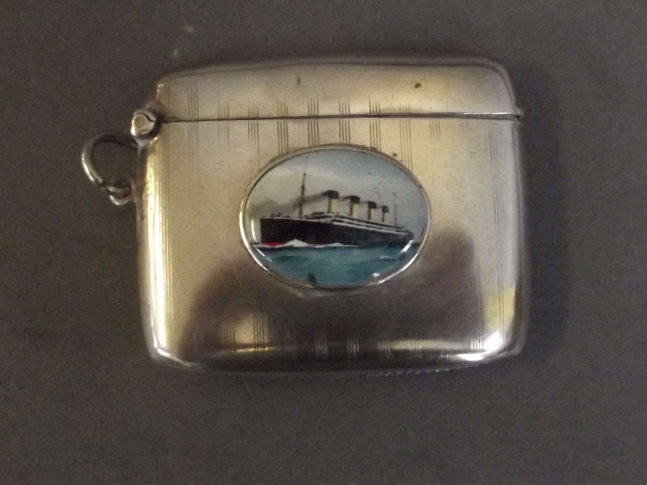 A silver vesta with an applied enamel of the Titanic, Birmingham 1911, 2¼'' wide