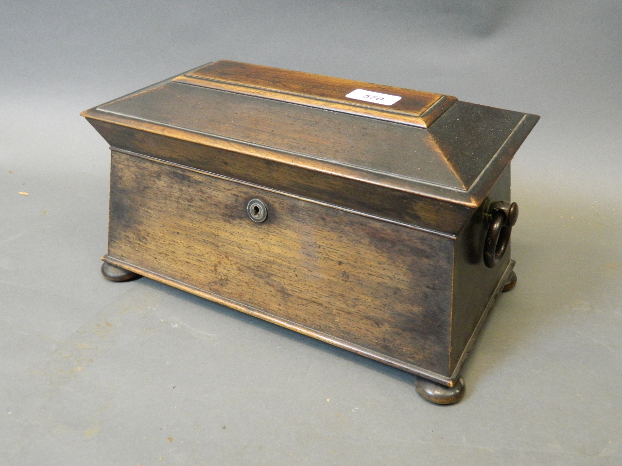 A good C19th rosewood two section sarcophagus shaped tea caddy with ring handles, the interior