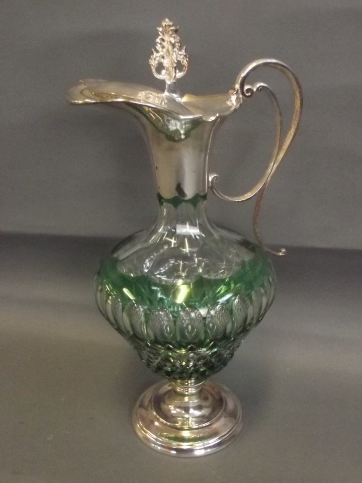 A silver claret jug with cut glass centre and green overlay, with an ornate knop, Sheffield 2010,