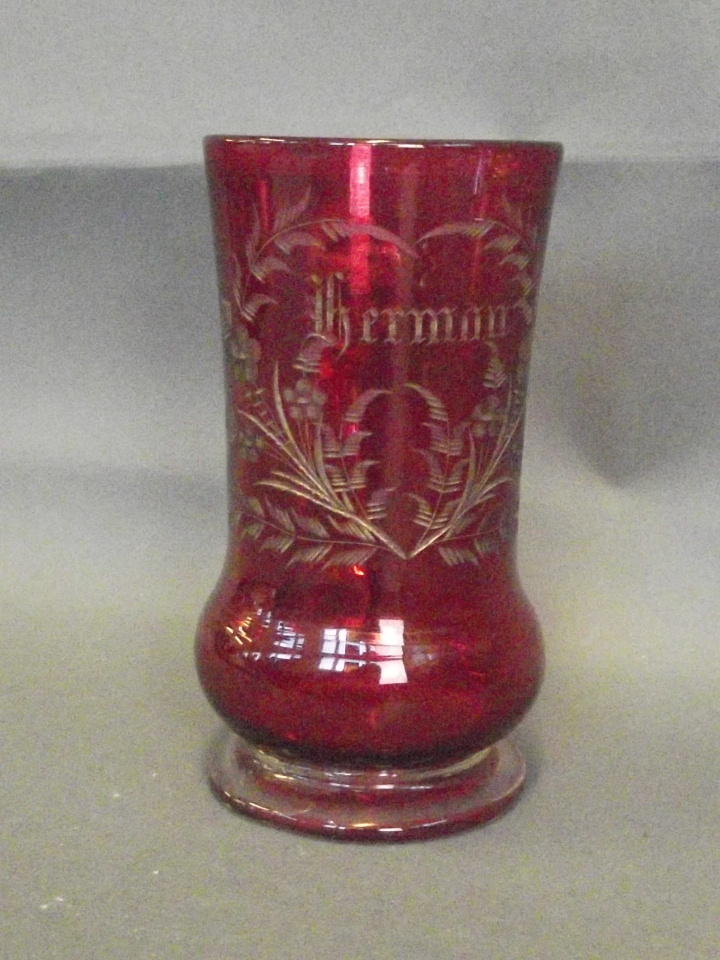 A Cranberry glass mug inscribed Herman in gilt script, 5¼'' high