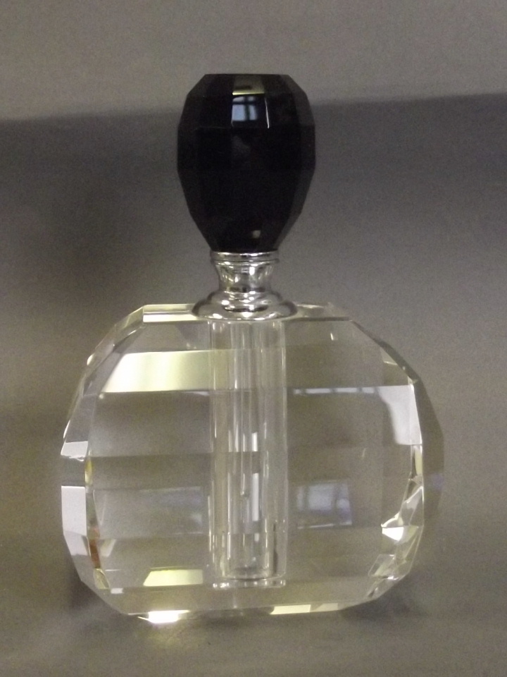 An Art Deco style scent bottle with a black shaped glass stopper, 5'' high