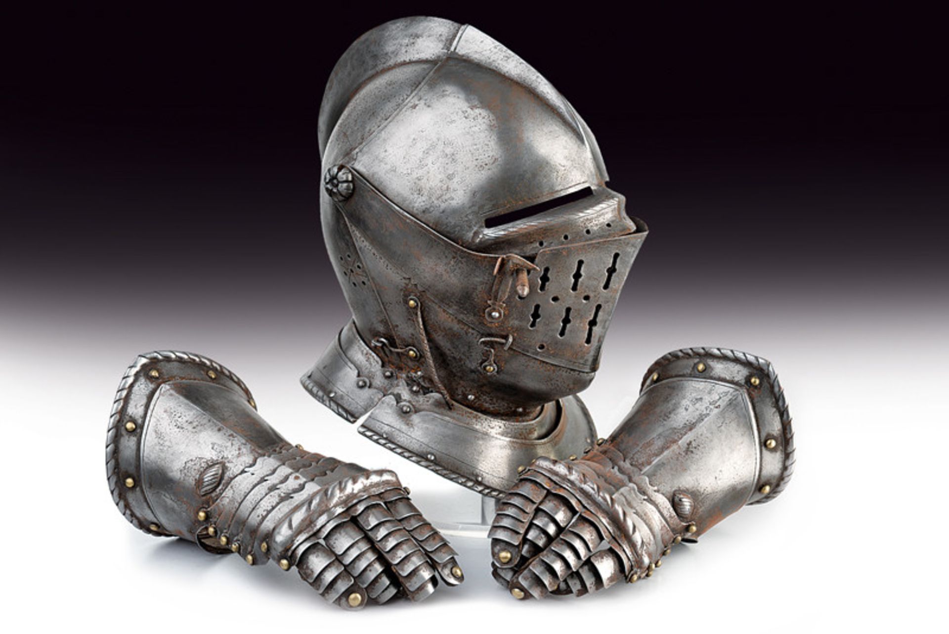 A helmet with a pair of gauntlets dating: 19th Century provenance: Europe Closed helmet with