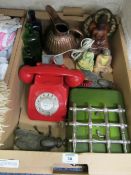 Box of assorted items including two cast metal fly ornaments, glass bottles, red telephone (