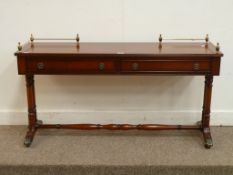 Reproduction mahogany two drawer stretcher table with brass gallery, W127cm