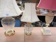 Two glass lamp bases with ivory damask shades and an alabaster lamp base