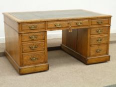Edwardian light oak twin pedestal desk fitted with nine drawers, inset green leather writing
