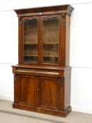 Victorian mahogany bookcase on cupboard with glazed doors and long single drawer, carved features,