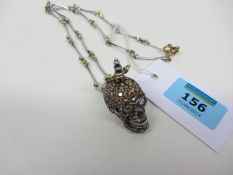 Skull pendant set with yellow and white diamonds on yellow and white bone link necklace stamped 750