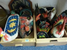 Collection of carved and painted wooden hens, etc in two boxes