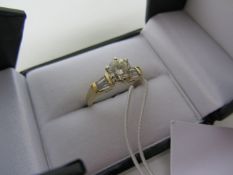 Ladies brilliant cut diamond ring with baguettes to shoulders stamped 18k approx 1.25 carat total