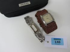 Fossil wristwatch with plaited leather strap and a Guess wristwatch