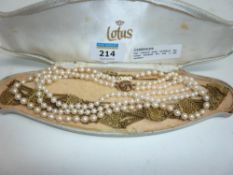 Two cultured pearl necklaces the clasps hallmarked 9ct and a gilt filigree necklace