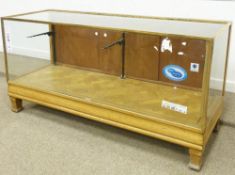 Edwardian oak four glass shop display counter, brass rule, parquetry base, makers label Elliotts