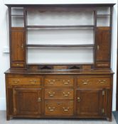 George III oak dresser and rack, the base with three drawers over two central flanked by two