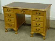 Mid 20th Century light oak twin pedestal desk with inset writing surface, ball and claw feet,