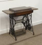 Singer sewing treadle machine mounted on cast iron table