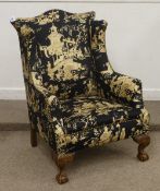 19th Century walnut framed wing back armchair upholstered in black and gold Chinoiserie cover,