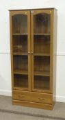 Pine finish glazed bookcase with two drawers