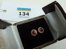Pair of ruby and diamond ear-rings tested to 18ct