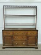 George III oak country dresser, enclosed by five drawers and two panelled cupboards, with three