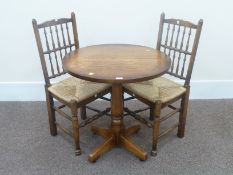 Solid oak circular pedestal table 76cm and two Lancashire spindle back chairs