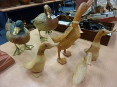 Two brass mounted models of ducks and further carved wooden ducks