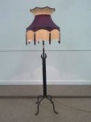 Wrought metal standard lamp with shade