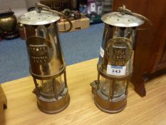A miner's brass safety lamp by The Protector Lamp and Lighting Co, bears super imposed brass
