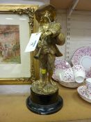 Continental ormolu model of man playing bag pipes, on wooden socle, bearing signature to front,