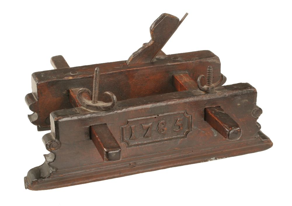 An 18c Dutch beech ploeg plough plane dated 1785 in cartouche with fruitwood stems and rams horn