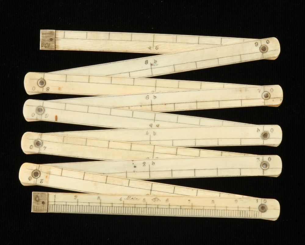 A 19c French 10 section ivory zigzag metre rule with German silver fittings marked BC in triangle