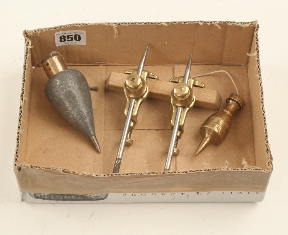 A pair of brass trammels marked A.M. 1943 and two plumb bobs