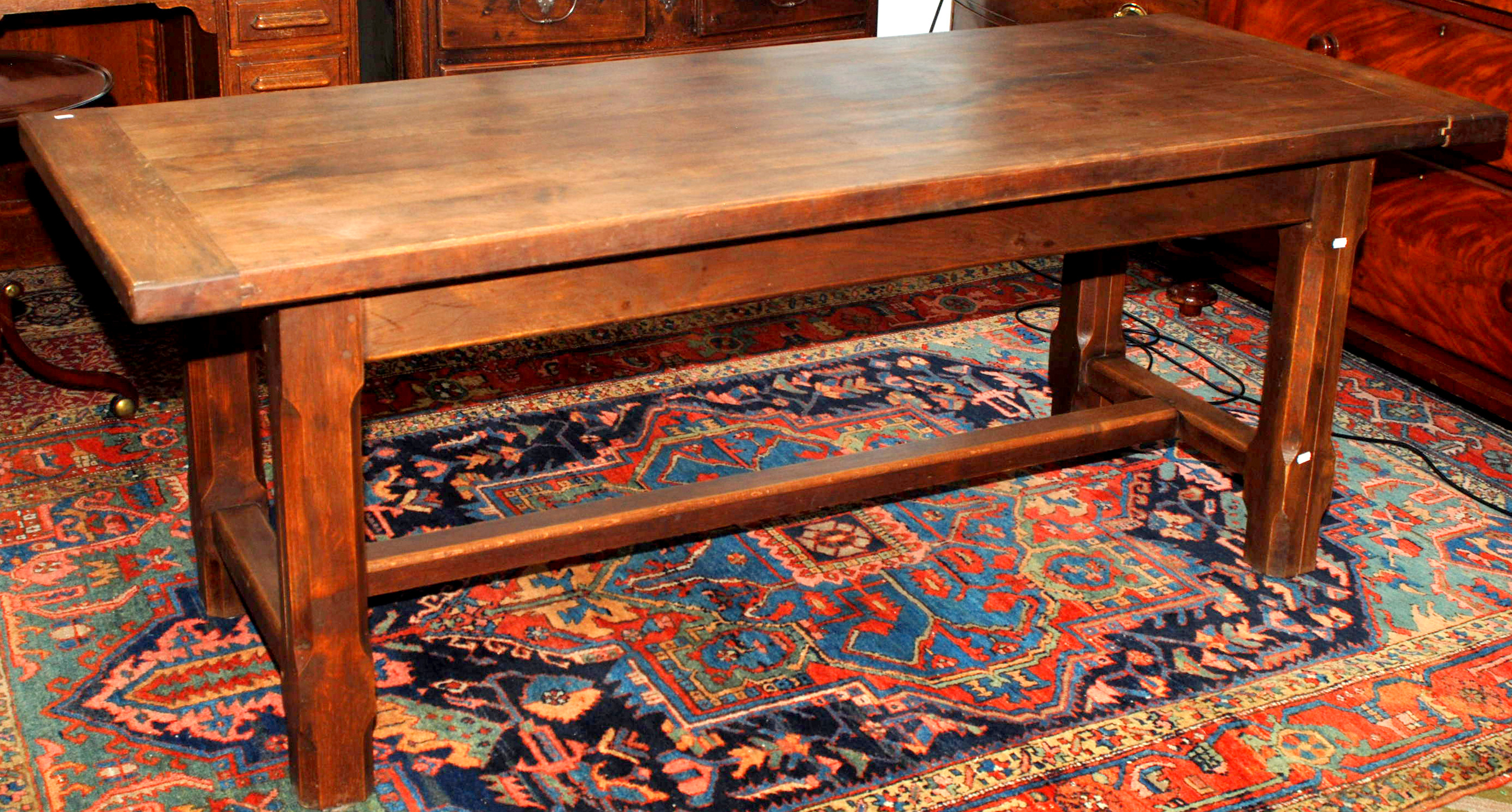 An oak refectory style table with boarded, cleated top on chamfered, square section legs with H