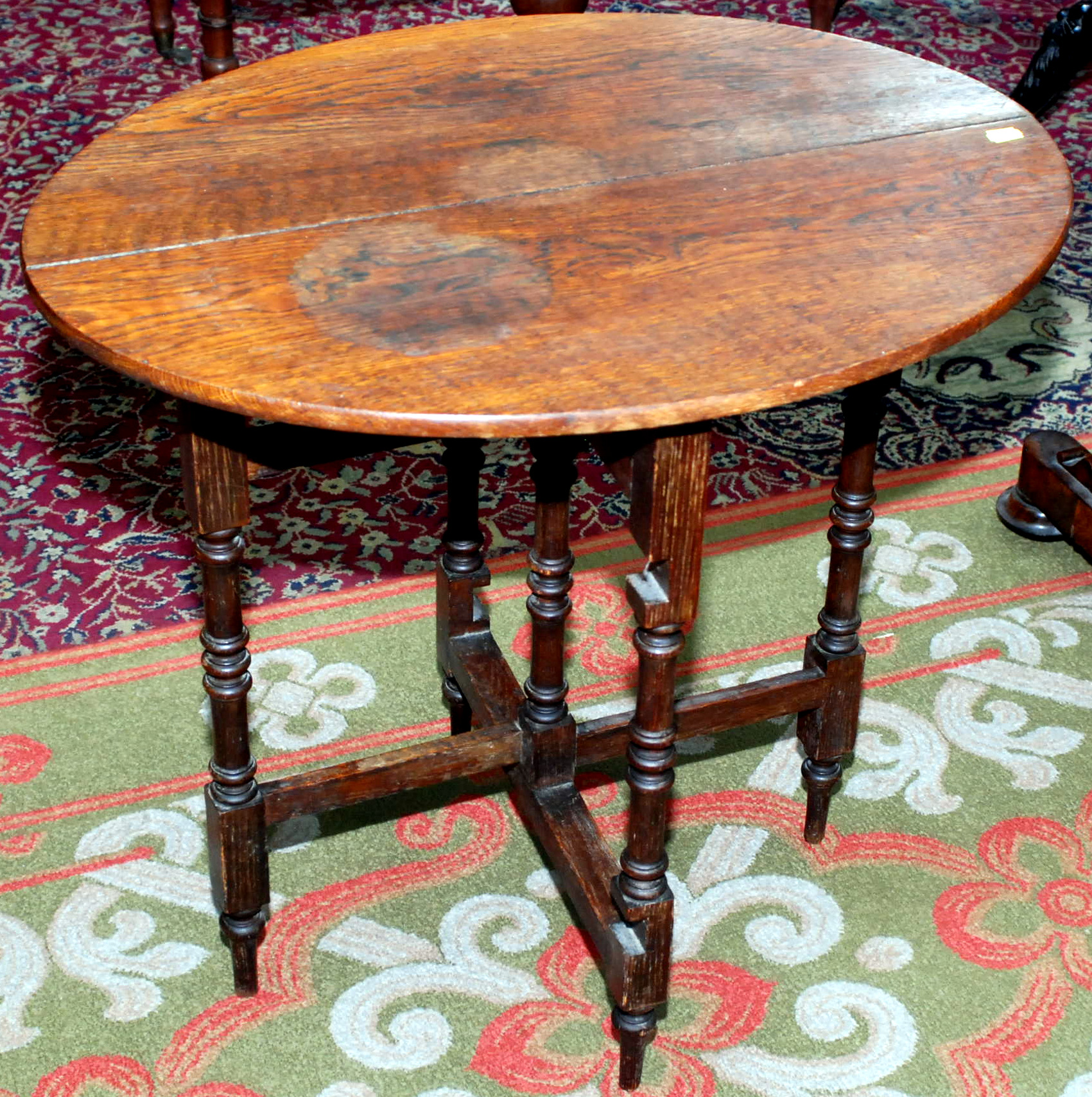 An oak, folding, oval occasional table.