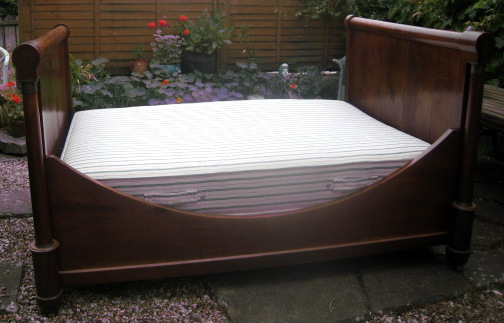 A mahogany lit bateau Empire Style 4ft 6ins bedstead.