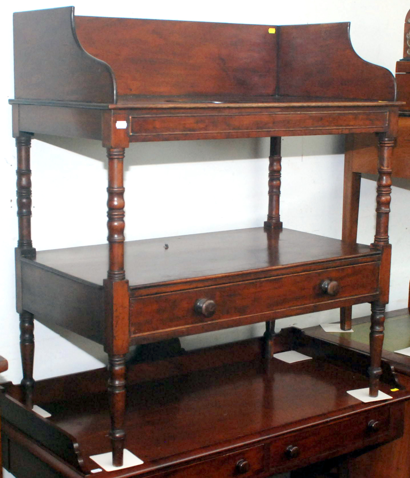 A George IV mahogany washstand with high plain gallery, the top pierced for a bowl, the low shelf
