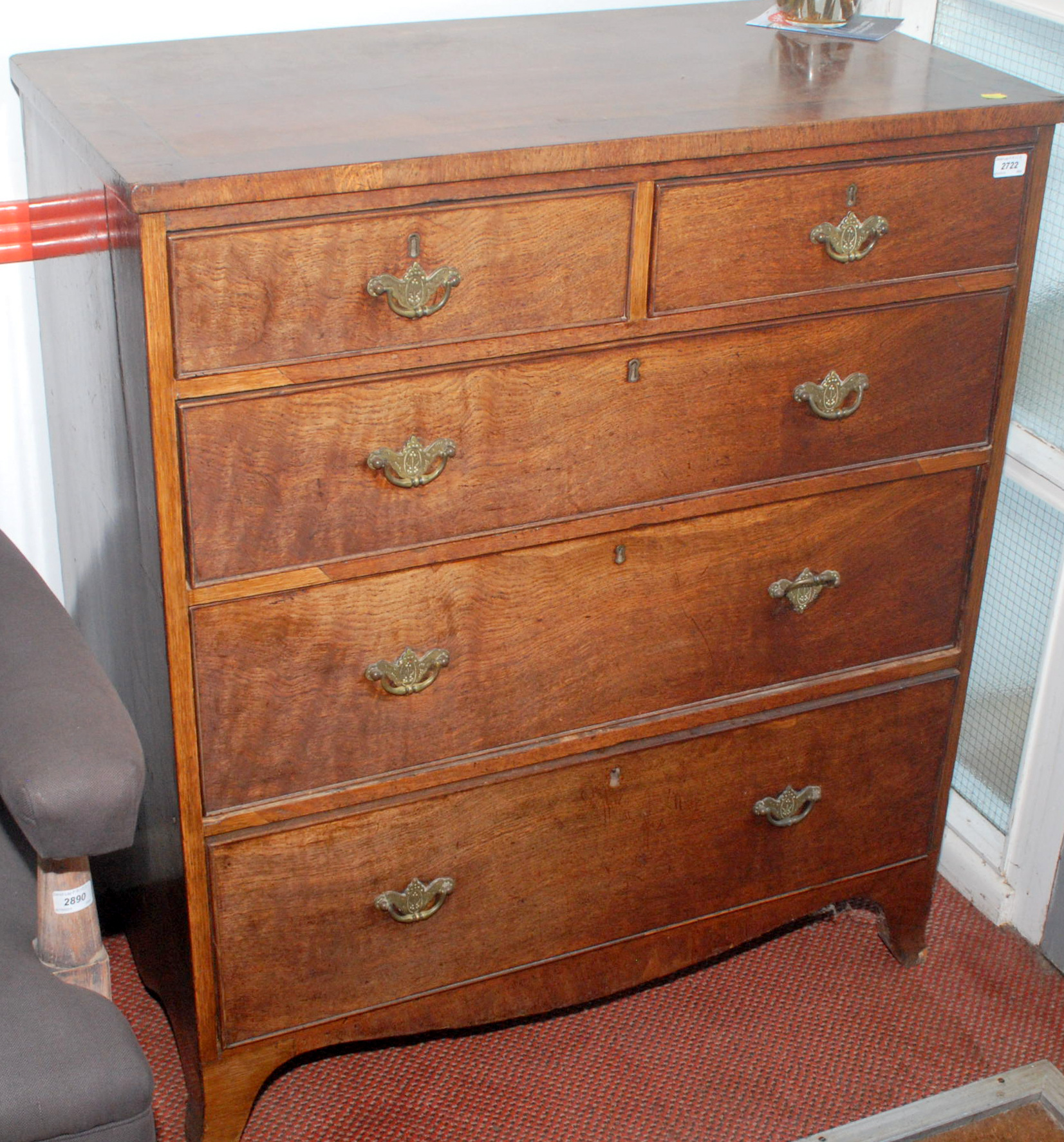 A late Georgian cross-banded oak chest of drawers.