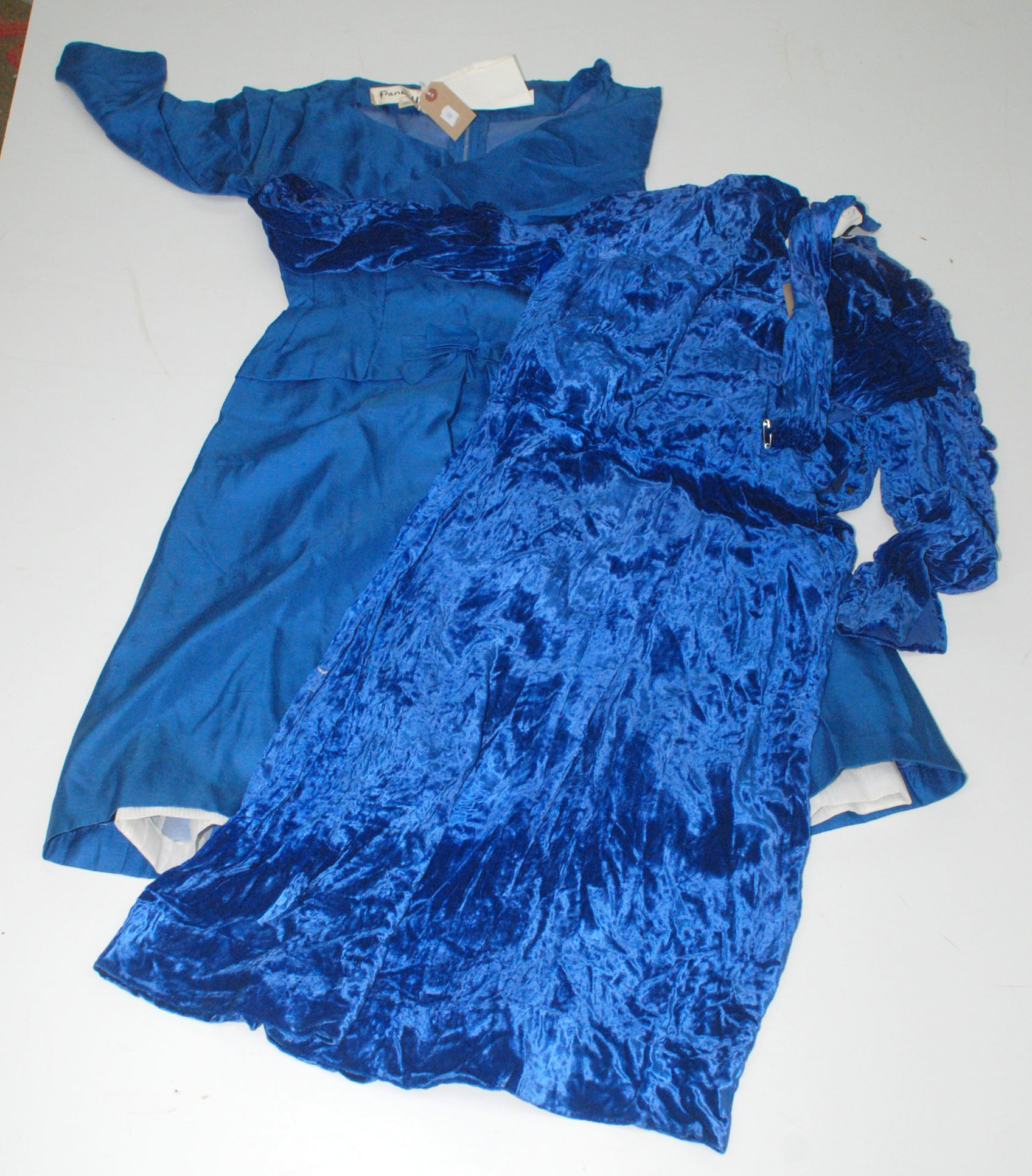 A 1920's silk velvet, deep blue dress, with a buttoned back and bows to the arms, velcro added