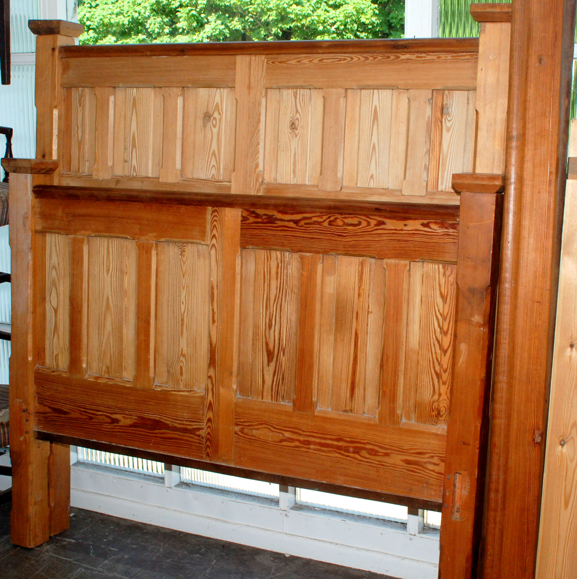 A pitch pine, king sized, panelled bedstead, width 168cm.