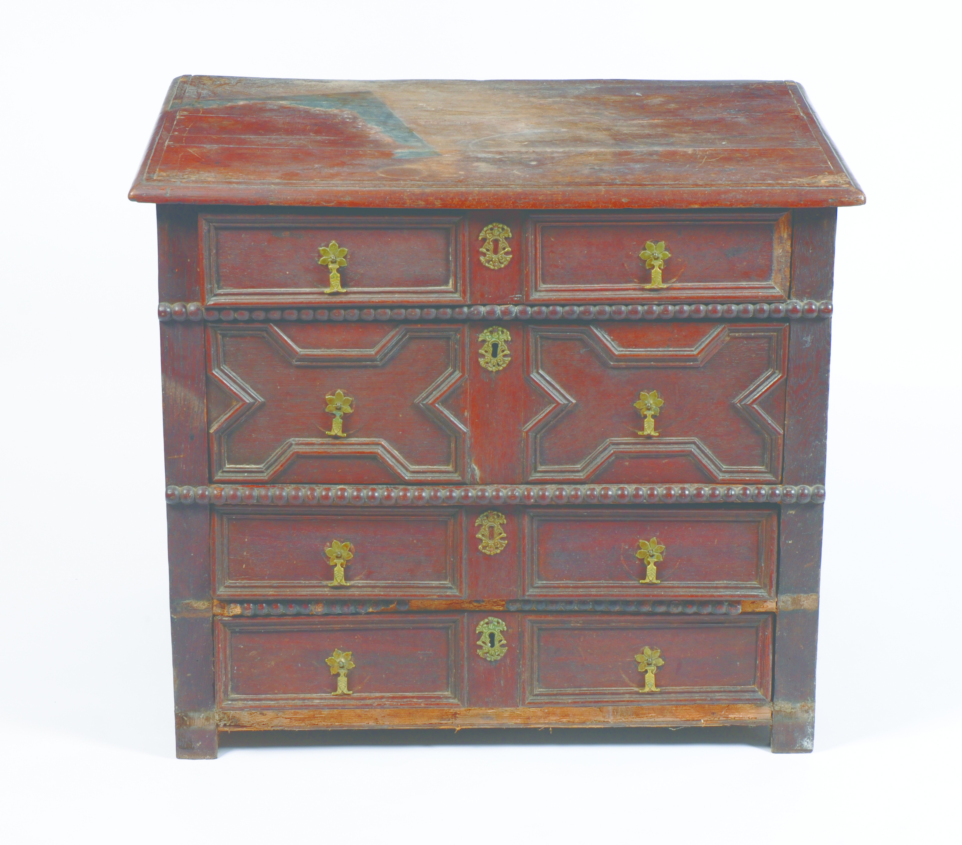 A rare late 17th or early 18th century oak chest of small proportions with four long drawers of