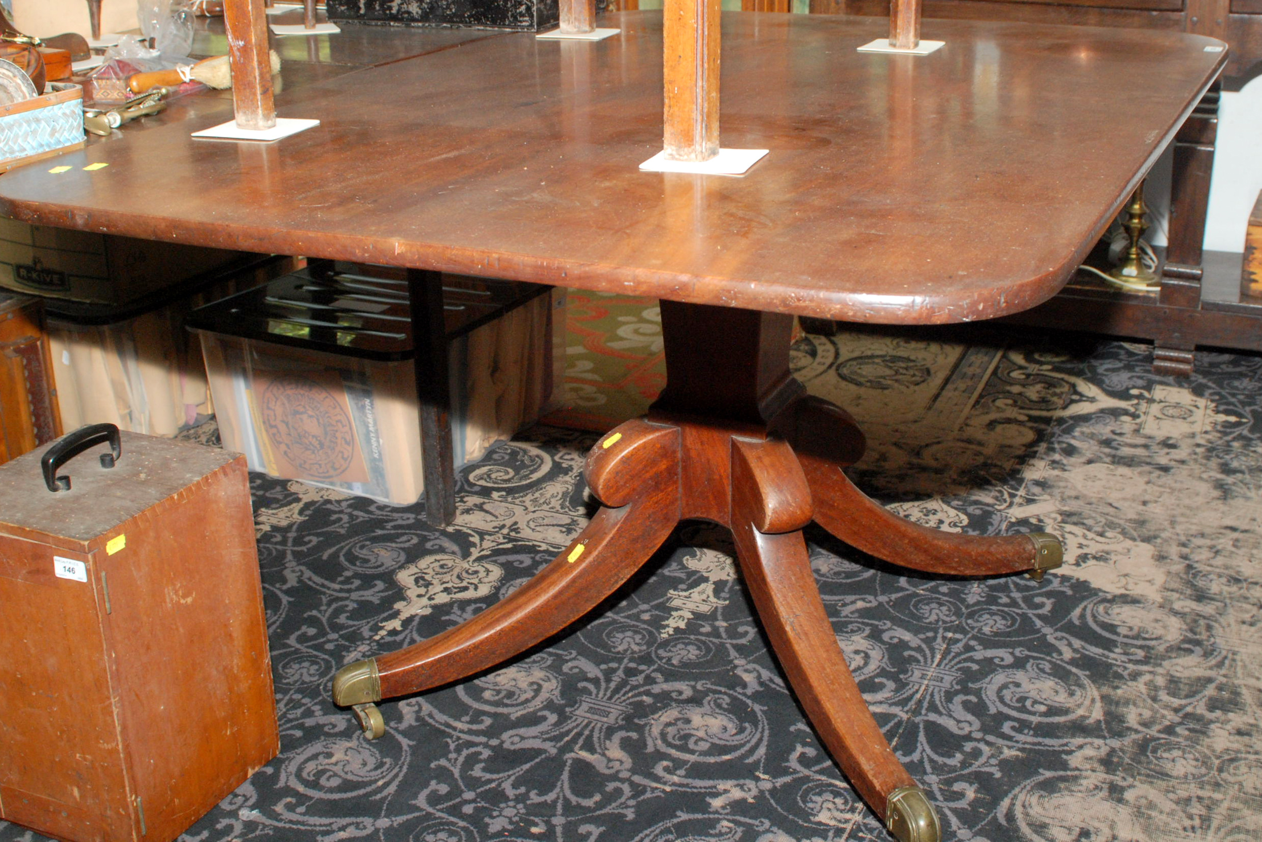 A Regency rectangular, mahogany, snap top table with square section vase pedestal and a quadruple