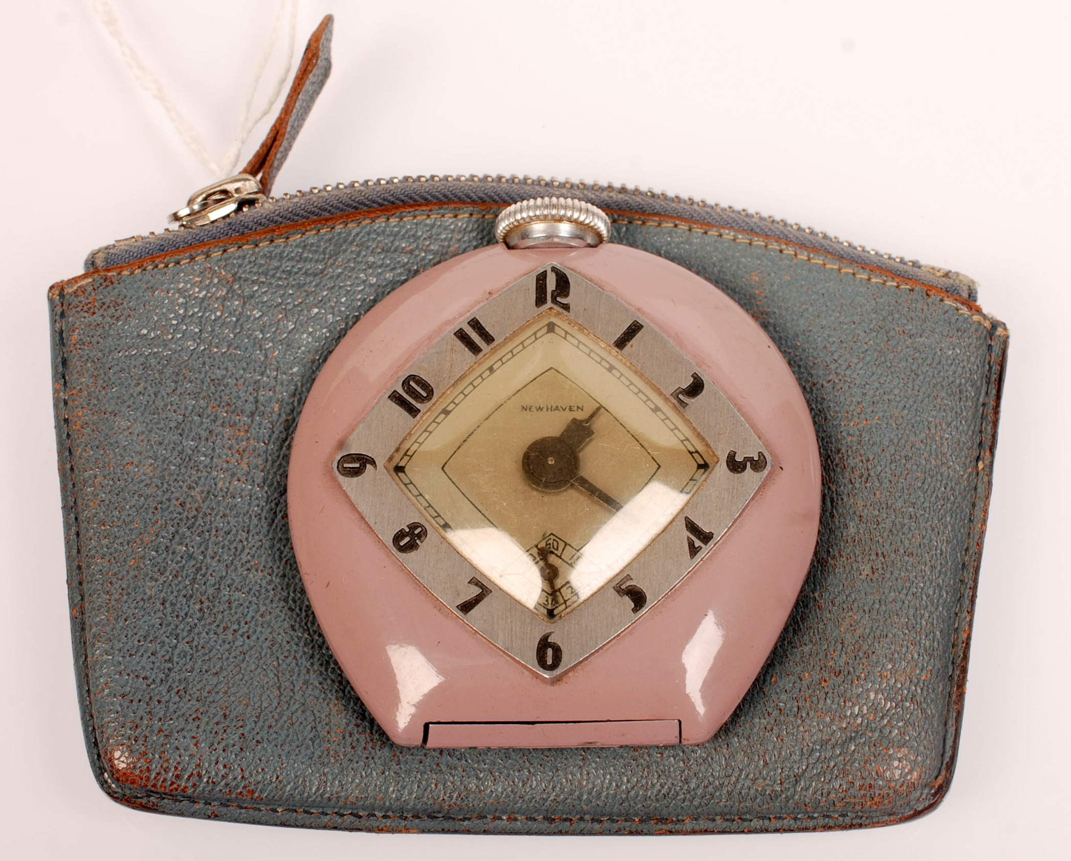 A Newhaven pre-war travelling timepiece with lilac enamelled case and stylish lozenge shaped chapter