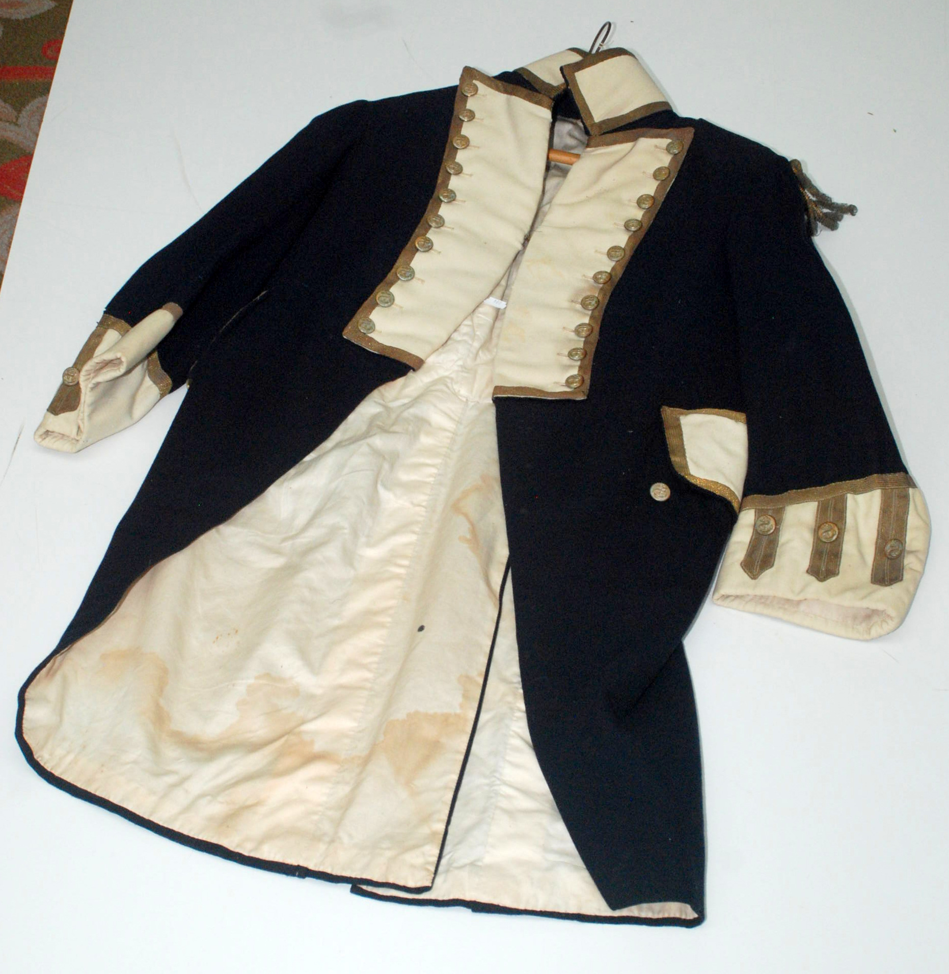 A Georgian naval greatcoat, braided, buttoned etc. Condition Report: Coat is small-medium in size.
