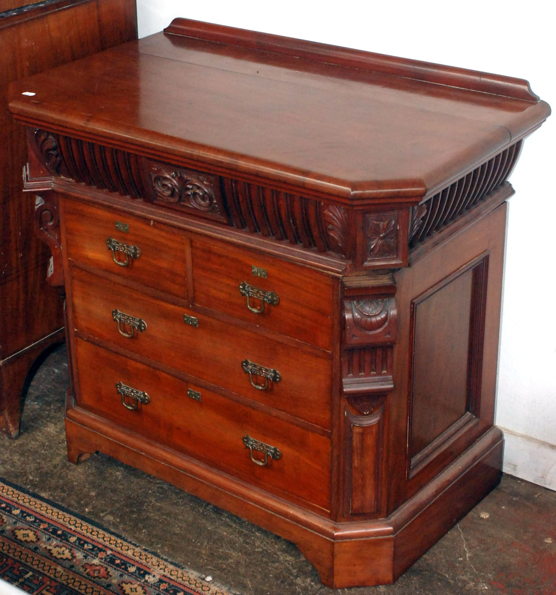 An unusual late Victorian chest of small proportions, the upper drawer moulded and with carved