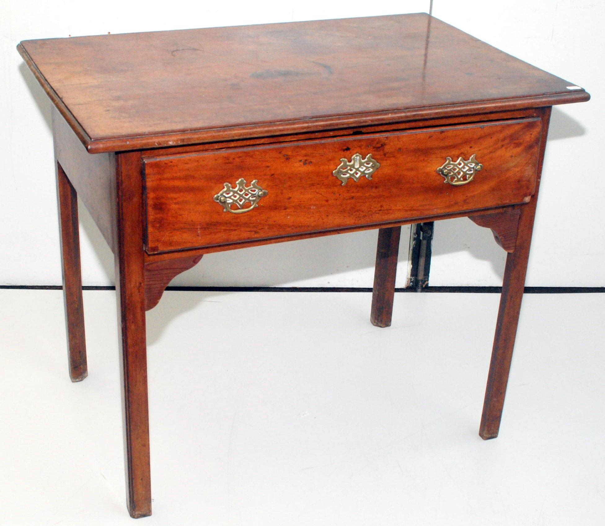 An early George III mahogany side table with moulded legs and single drawer on square section,