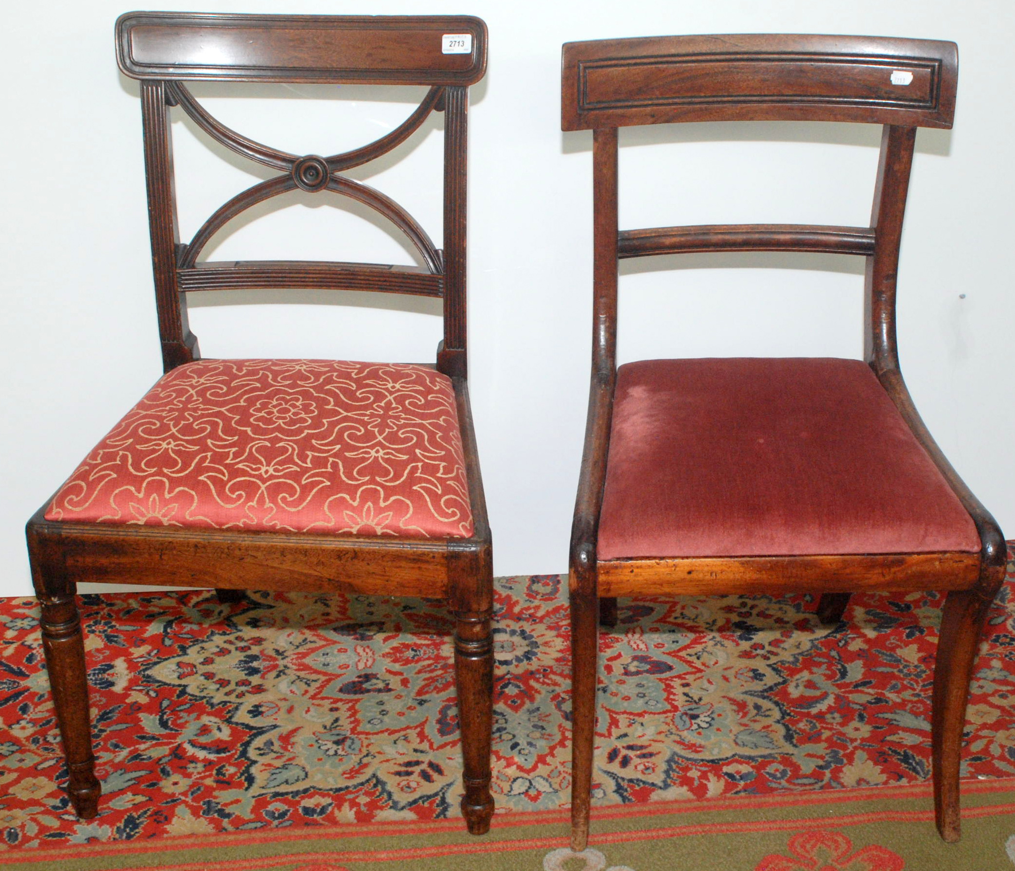 A pair of Sheraton period mahogany dining chairs each with wide moulded crest rail and curving X