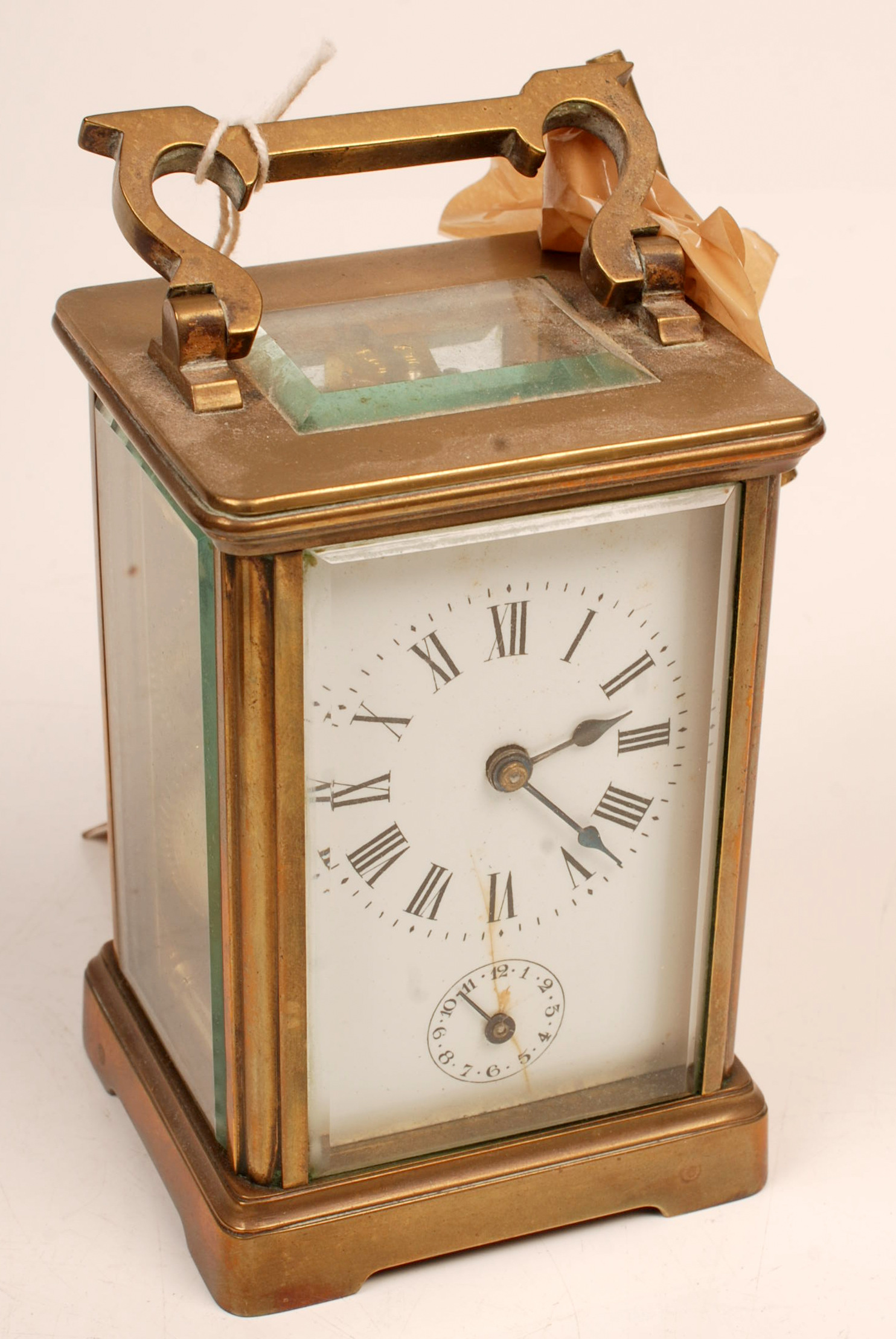 An alarm carriage clock in brass corniche case.
